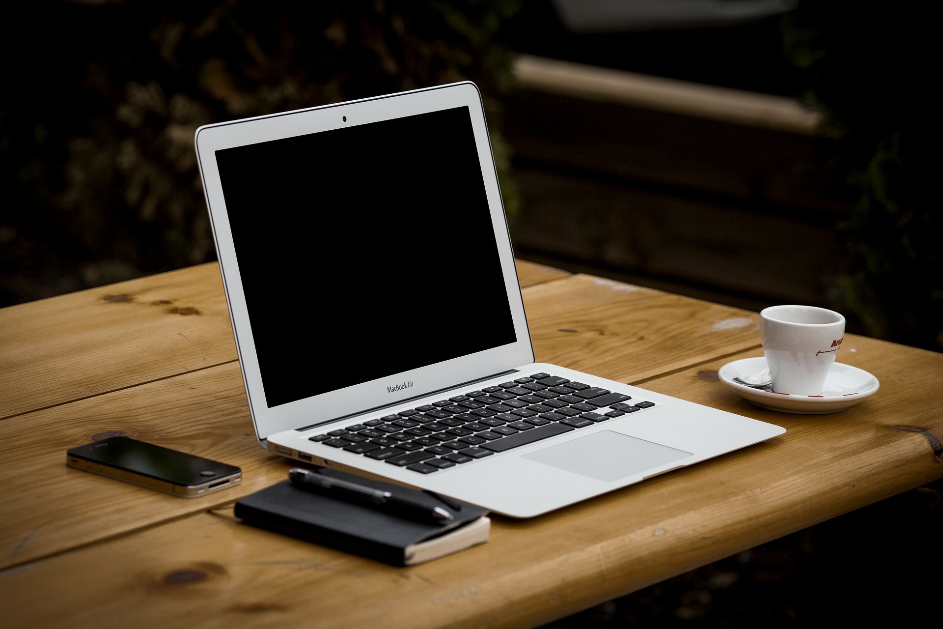 Schreibtisch mit Laptop, Kaffeetasse und Schreibutensilien